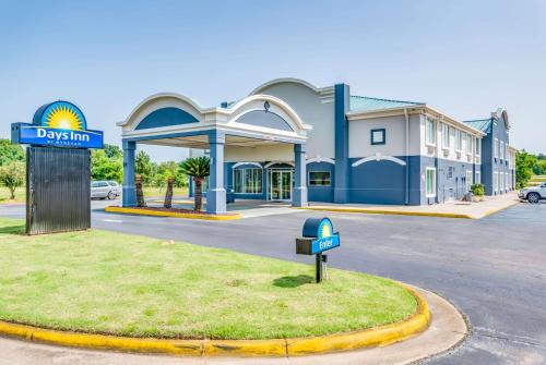 a sign in front of a building with a parking lot at Days Inn by Wyndham Coliseum Montgomery AL in Montgomery