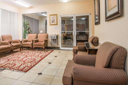a waiting room in a hospital with chairs and a rug at Days Inn by Wyndham Coliseum Montgomery AL in Montgomery