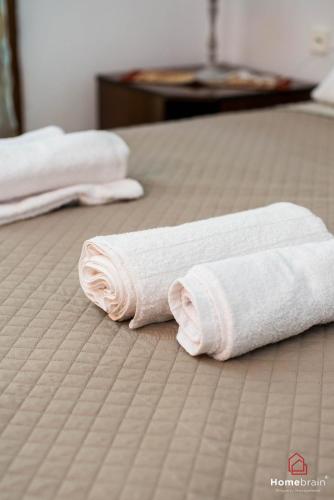 two towels on a bed in a hotel room at VILLA ROSSA in Mesimvría