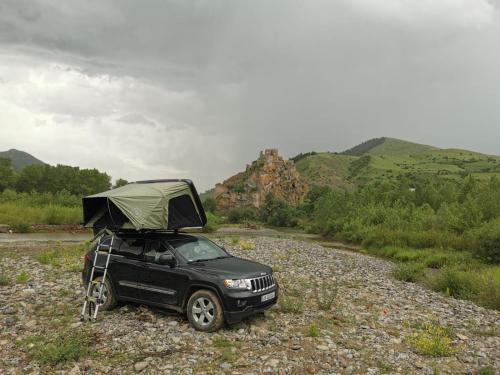 a black car with a camper on top of it at Rent4travel in Tbilisi City