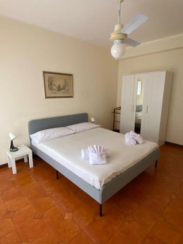 a bedroom with a bed with two towels on it at AV Apartment in Aci Castello