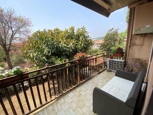 a balcony with a table and chairs on a fence at AV Apartment in Aci Castello