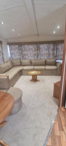 a living room with a couch and a table at Beautiful 3 bedroom holiday home Amazing views in Gisburn