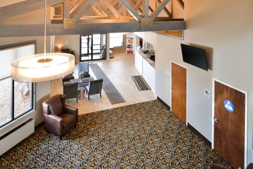 an open living room with a couch and a chair at Wingate by Wyndham Beaver I-15 in Beaver