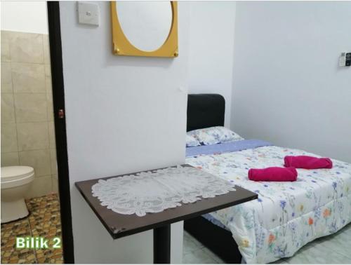 Кровать или кровати в номере Kampung Vibe @ Homestay Baiduri