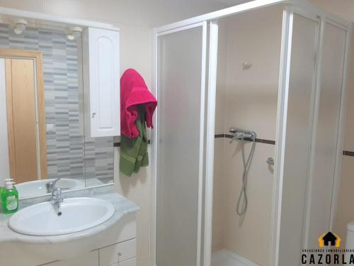 a white bathroom with a sink and a shower at CASA CARMELA in Cazorla