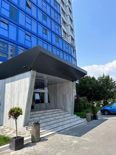 a building with a staircase in front of a building at OLIMP Sea View Apartments - The Sunny Apartment in Olimp
