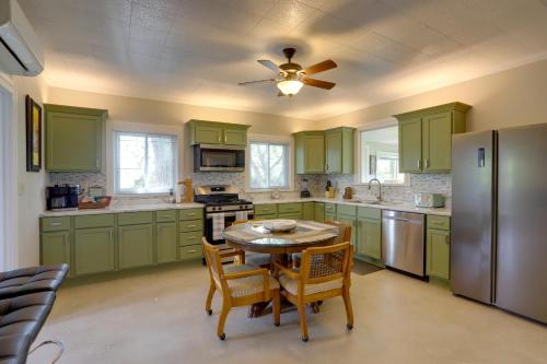 a kitchen with green cabinets and a table with chairs at Welcoming Port Clinton Vacation Rental! in Port Clinton