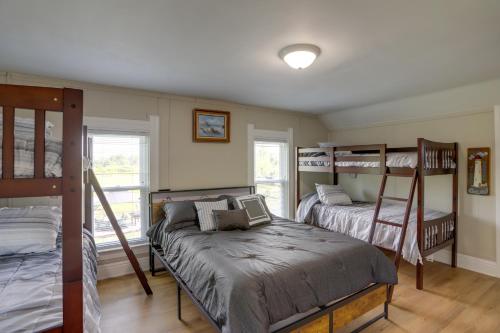 a bedroom with three bunk beds and a window at Welcoming Port Clinton Vacation Rental! in Port Clinton