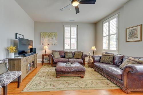 a living room with leather furniture and a flat screen tv at Winston-Salem Vacation Rental - Walk Downtown! in Winston-Salem