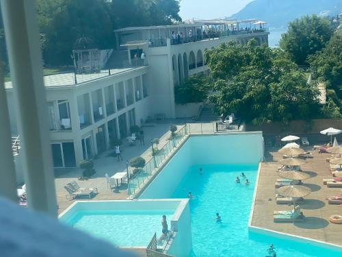 a view of a swimming pool with people in a hotel at Best View Stylish Penthouse in Corfu Town