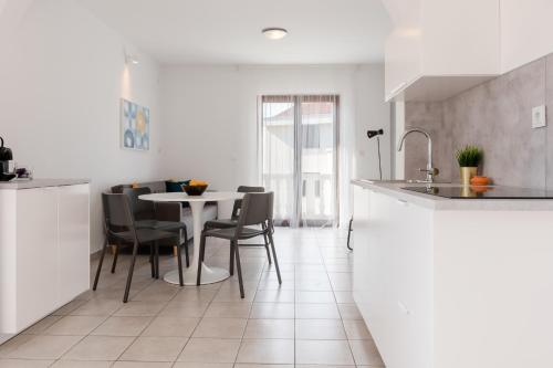 - une cuisine et une salle à manger avec une table et des chaises dans l'établissement Apartment in Silo with Two-Bedrooms 1, à Šilo