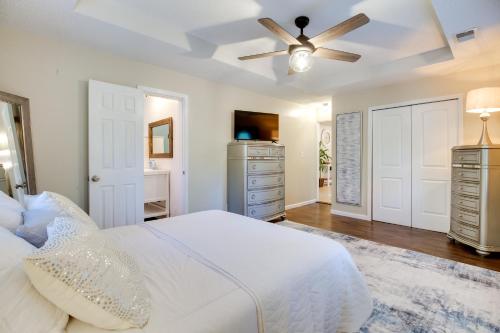 a bedroom with a white bed and a ceiling fan at Southern Escape in Guyton Private Yard and Hot Tub! in Port Wentworth