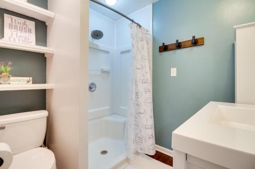 a bathroom with a shower and a toilet and a sink at Southern Escape in Guyton Private Yard and Hot Tub! in Port Wentworth