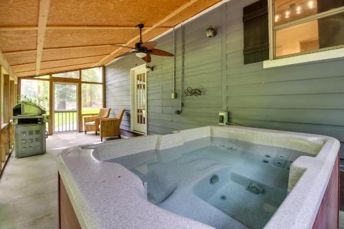 a large bath tub in a room with a kitchen at Bright Guyton Home with Private Yard and Hot Tub! in Port Wentworth