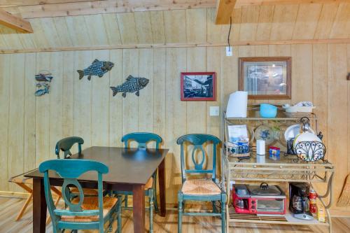 a dining room with a wooden table and chairs at Emory Studio Cabin with Lake Fork Boat Access! in Emory