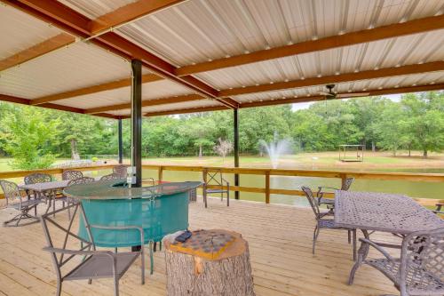 a covered deck with tables and chairs and a fountain at Emory Studio Cabin with Lake Fork Boat Access! in Emory