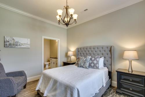 a bedroom with a bed and a chair and a chandelier at Swim, Golf and Bowl - Loretto Vacation Rental Apt! in Loretto