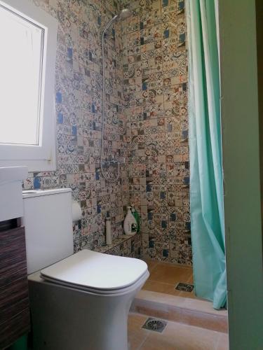 a bathroom with a toilet and a shower at Vacation House in Agiokampos in AgiaKampos