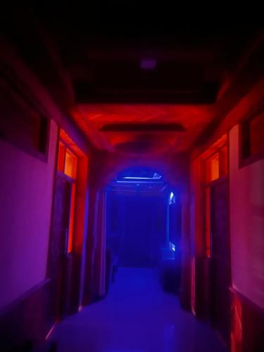 a dark hallway with red and blue lights at Norvin Homes in Shimla