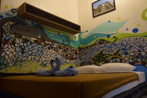Postel nebo postele na pokoji v ubytování Pondok IJo Guesthouse