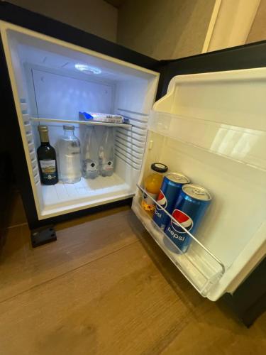 an open refrigerator with food and drinks in it at 4heavens_naples in Naples