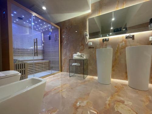a bathroom with a tub and a toilet and a shower at 4heavens_naples in Naples