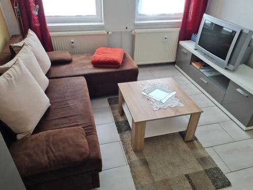 a living room with a couch and a coffee table at Ferienwohnung Ribnitz-Damgarten in Ribnitz-Damgarten