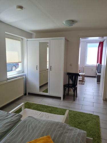 a bedroom with a bed and a room with a table at Ferienwohnung Ribnitz-Damgarten in Ribnitz-Damgarten