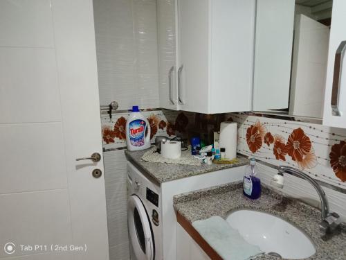 a kitchen with a sink and a washing machine at Rainfort apart Pınarkent 2+1 in Pamukkale