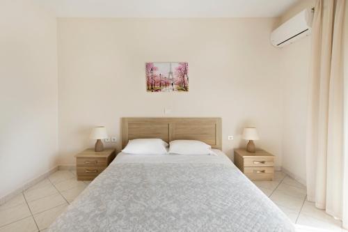 a bedroom with a large bed with two night stands at Kostas 2 in Kos