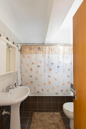 a bathroom with a sink and a toilet at Kostas 2 in Kos