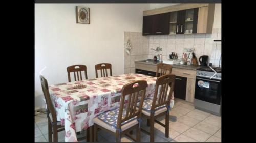 a kitchen with a table with four chairs and a stove at Apartmans sabovic in Ulcinj
