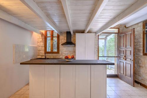 a kitchen with white cabinets and a counter top at Rogalida in Lambiní
