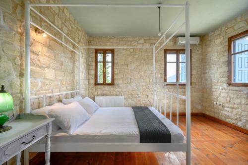 a bedroom with a bed in a brick wall at Rogalida in Lambiní
