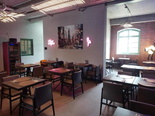 a dining room with tables and chairs and a brick wall at SEA YOU in Klink