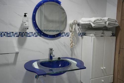 a bathroom with a blue sink and a mirror at Mediterraneo in Faro de Cullera