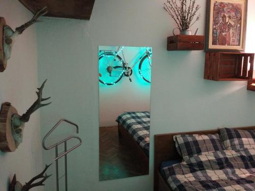 a mirror in a bedroom with a bike on the wall at Cozy Apartment near tram station in Zagreb