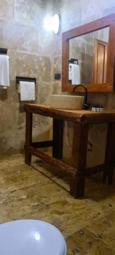 a bathroom with a wooden sink and a mirror at Cappadoo 