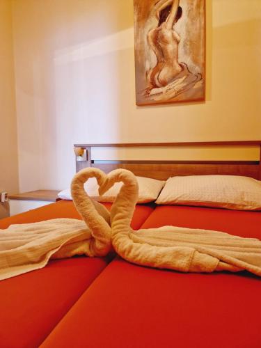two swans making a heart on a bed at Guest House Sombrero in Senj