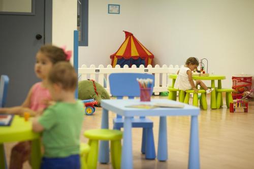 a group of children sitting in a play room at Apartamentos Alday in Maliaño