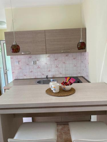 a kitchen counter with two cups and a sink at Apartments Lalević in Donji Morinj