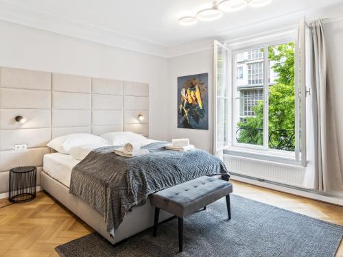 a white bedroom with a bed and a window at SKY9 Apartments Schönbrunn Palace in Vienna