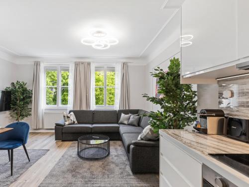 a living room with a couch and a table at SKY9 Apartments Schönbrunn Palace in Vienna