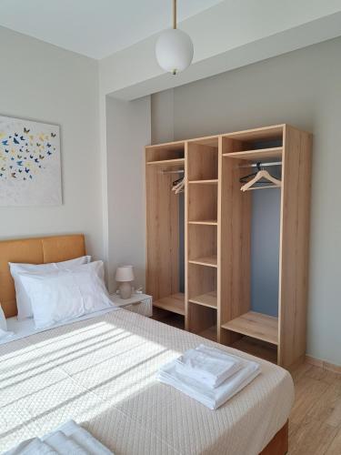 a bedroom with a bed with a closet and shelves at Christine luxury villa in Kolymvari