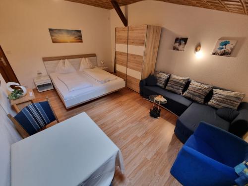 Habitación pequeña con cama y sofá en Alpen-Appartementhof, en Bad Hofgastein