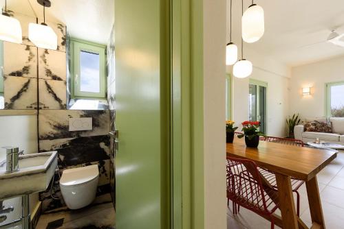 a bathroom with a sink and a table in a room at Plioni Villas With Private Pool & Suites With Hot Tub in Mikri Vigla