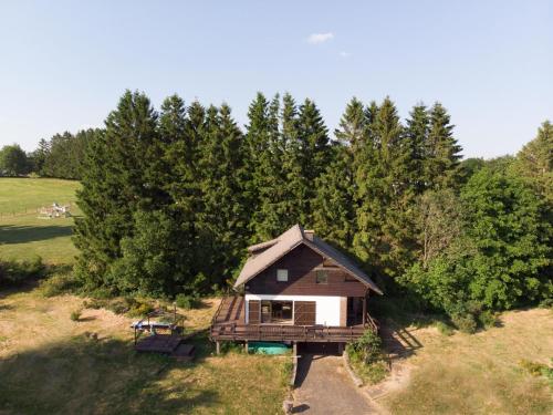 an overhead view of a small house in a field at Typical Ardennes chalet with hot tub in Ovifat