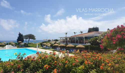 a resort with a swimming pool and some flowers at Typical TM Flat with a Terrace and Sea View in VSR in Porches