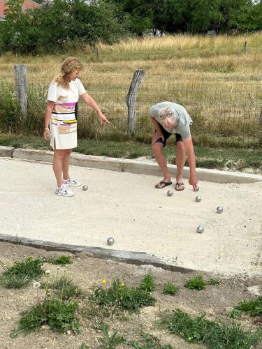 two women playing with balls on a sidewalk at Gite une belle Histoire in Voisey